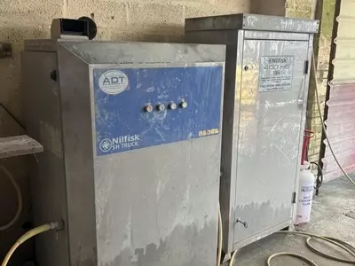 Nilfisk SH Truck Booster and DTE 500 HS pressure washer system before servicing, showing dirt build-up and signs of heavy use prior to a full service and performance restoration.